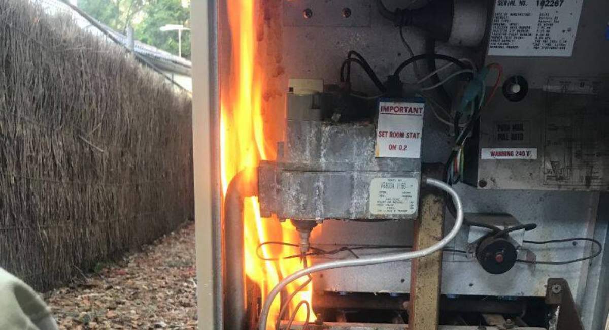 Faulty outdoor ducted gas heater on fire
