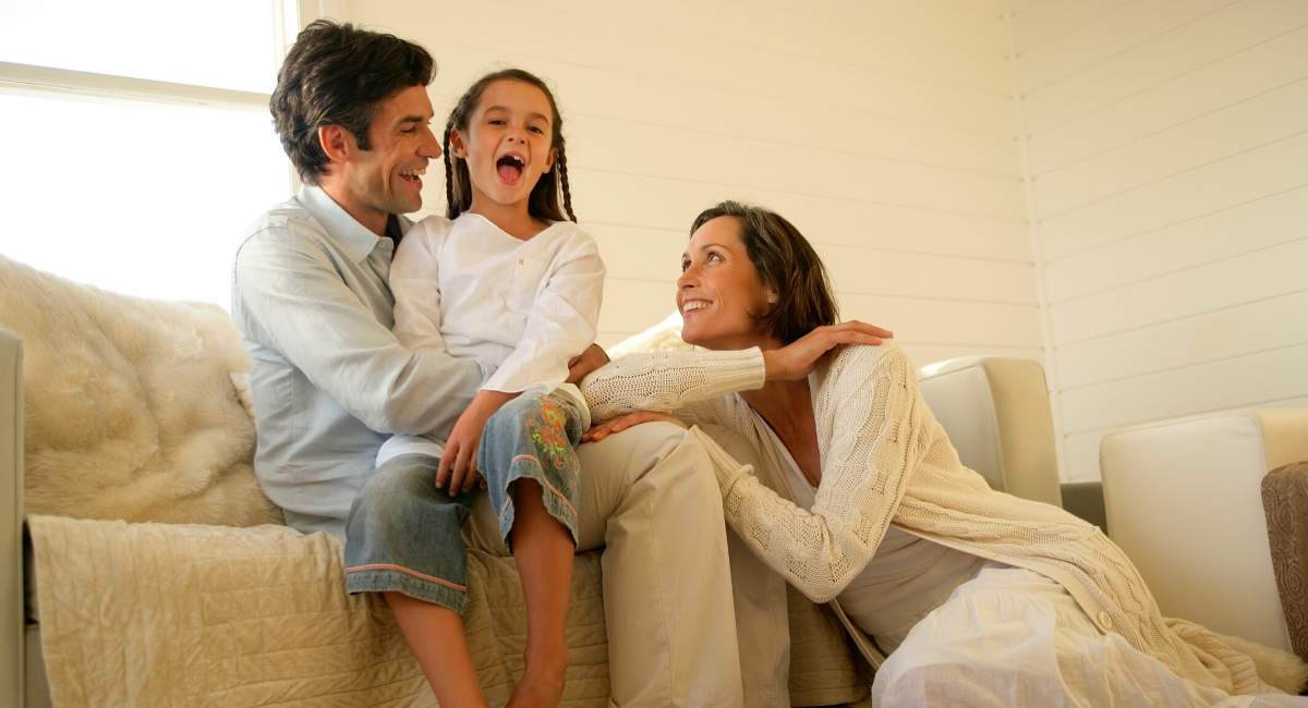 Family smiling in living room