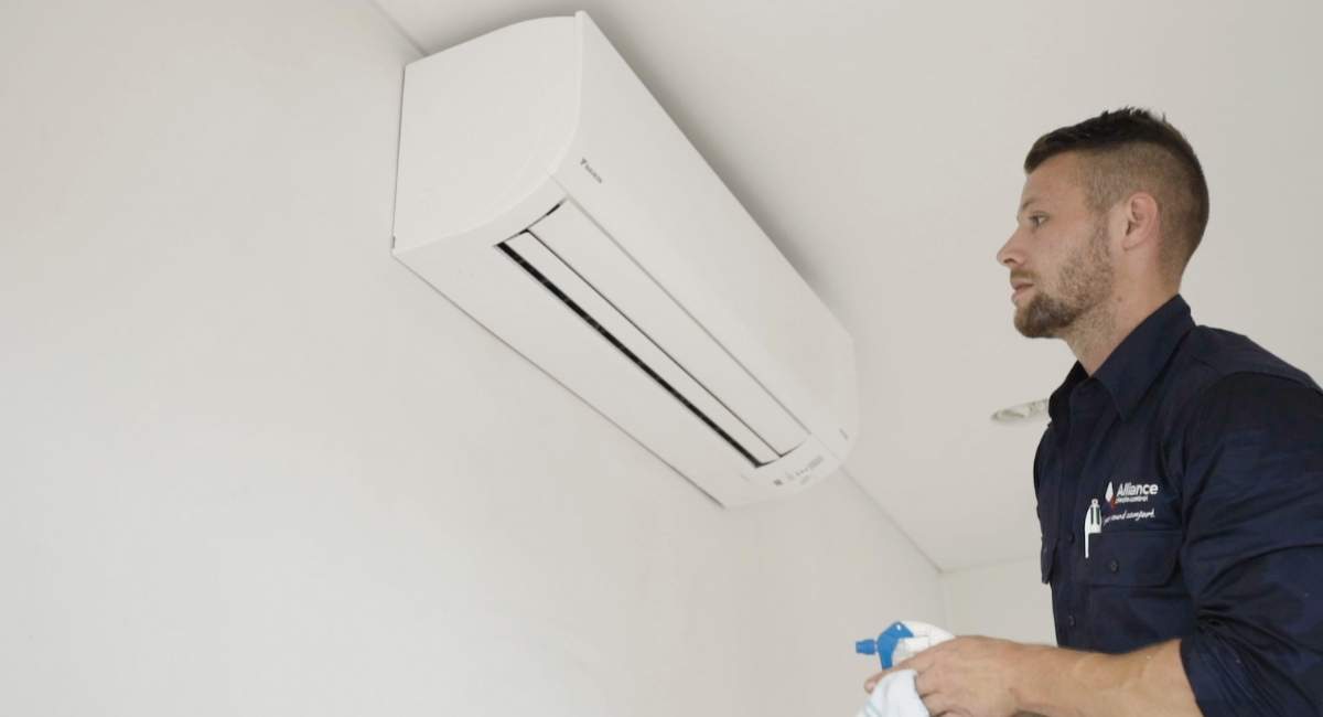 Man with new wall mounted air conditioning system